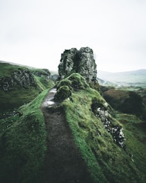 pathway near rock formation during daytime