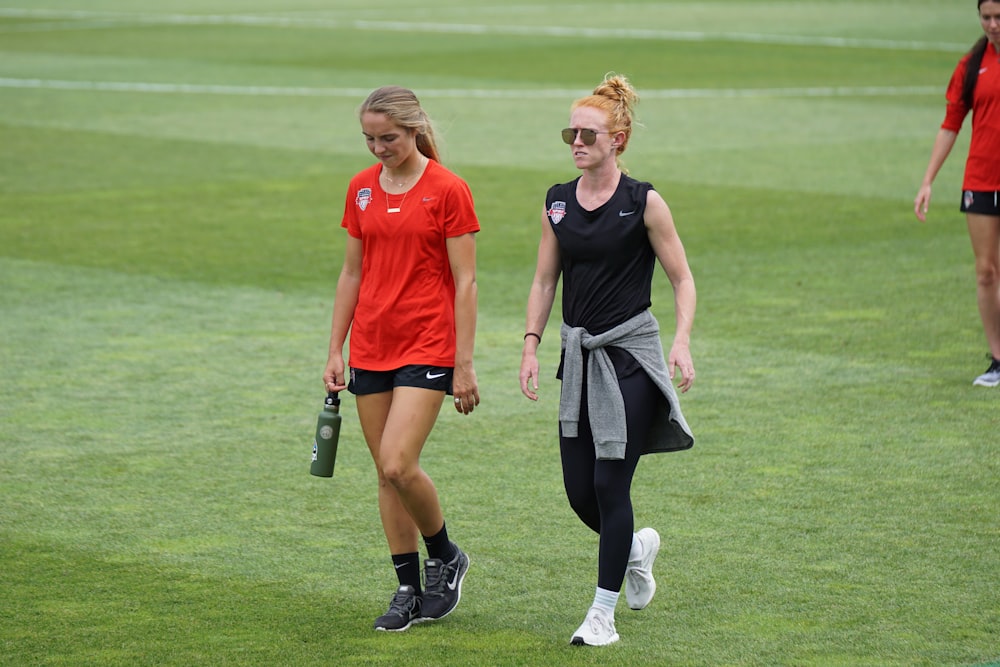 two woman walking beside each other