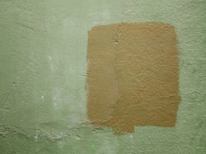 Smooth, freshly repaired and painted drywall ceiling patch.