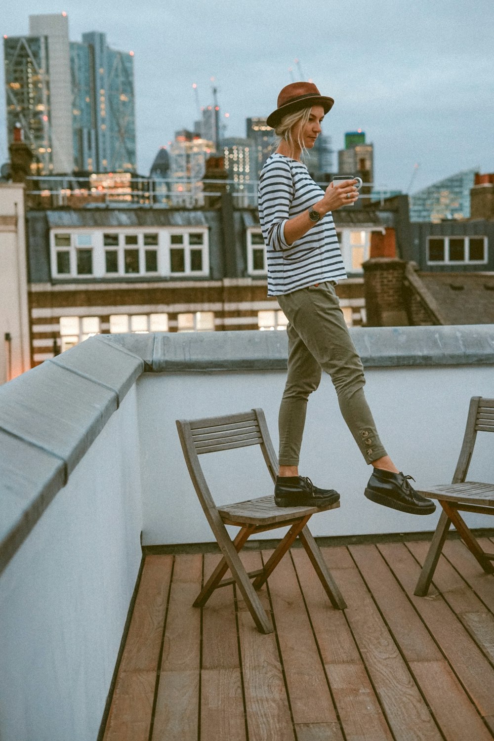 man standing on wooden chair