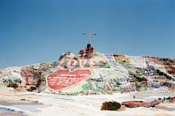 assorted-color land formation with cross on top