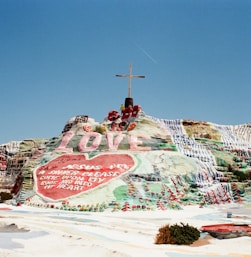 assorted-color land formation with cross on top