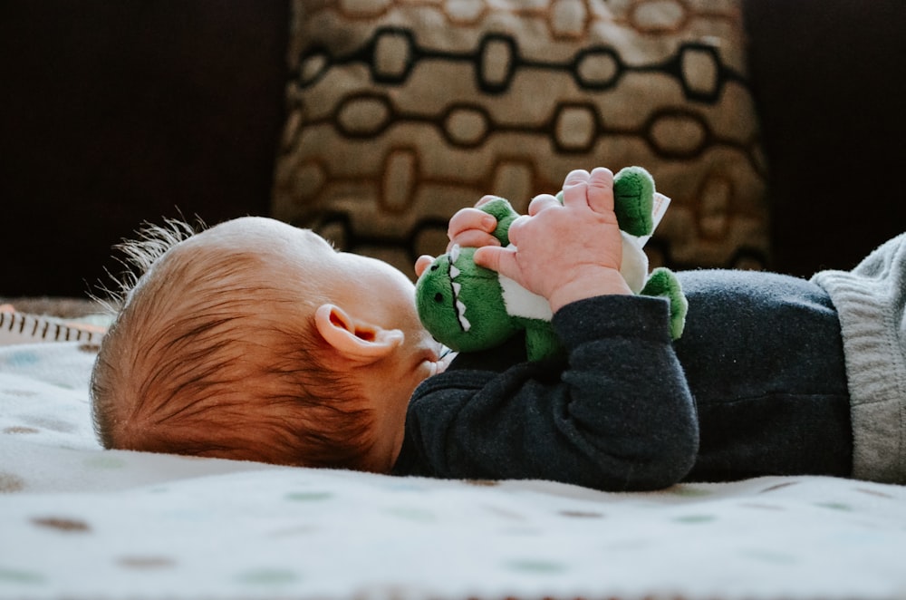 baby lying on white bed