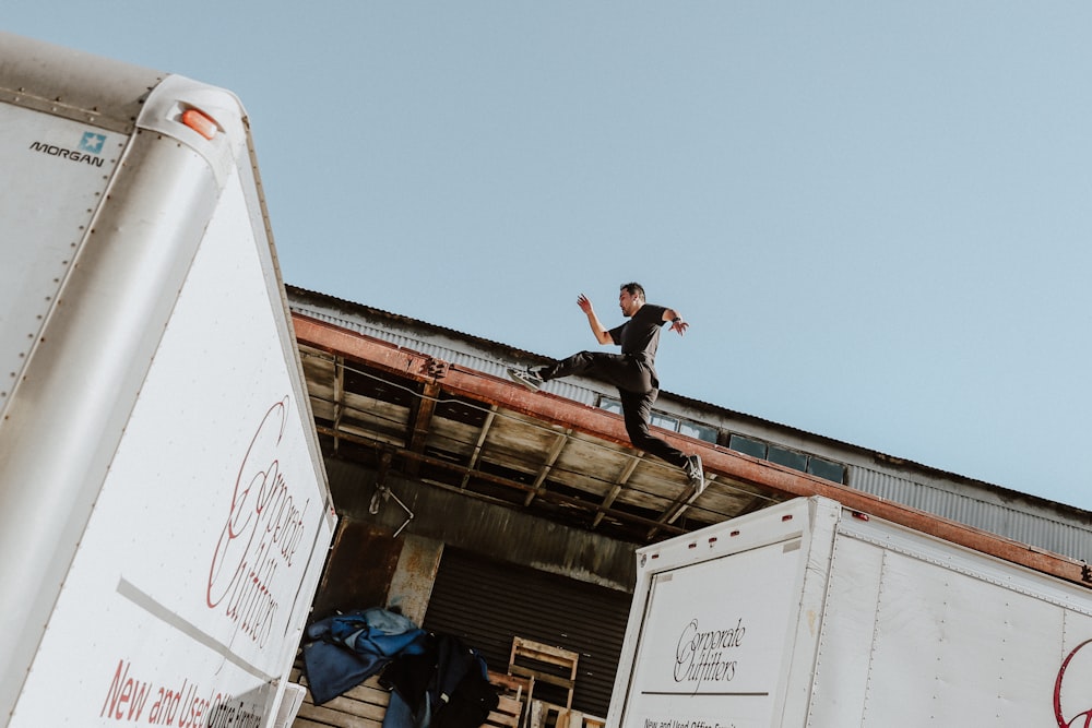 person doing parkour on top of truck