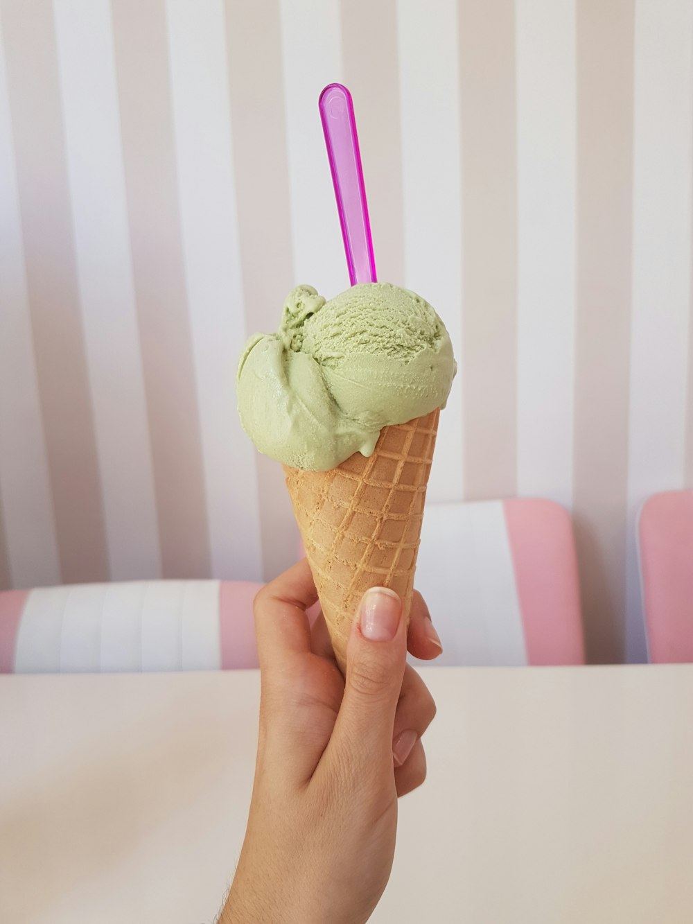 woman holding green ice cream