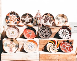 Handcrafted pottery and woven baskets displayed on a rustic wooden table