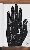Close-up of a notebook featuring a moon phases design in black ink.