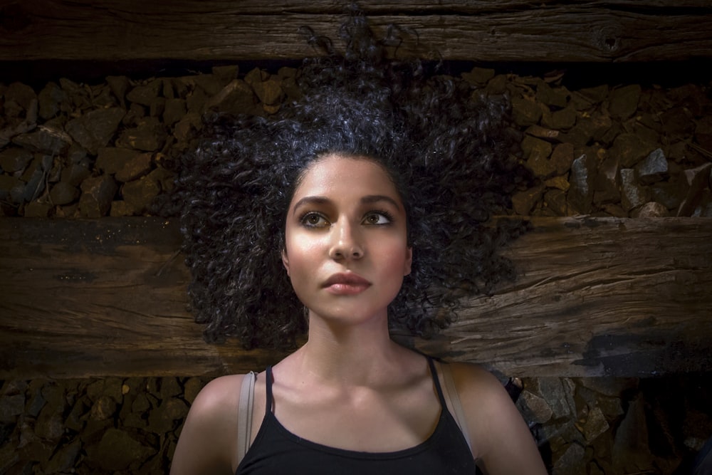 woman lying on brown plank