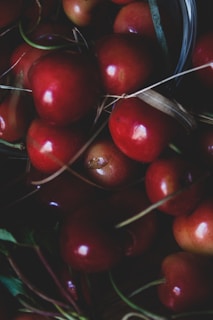 Close-up of ripe cherries and seasonal produce highlighting freshness and quality.