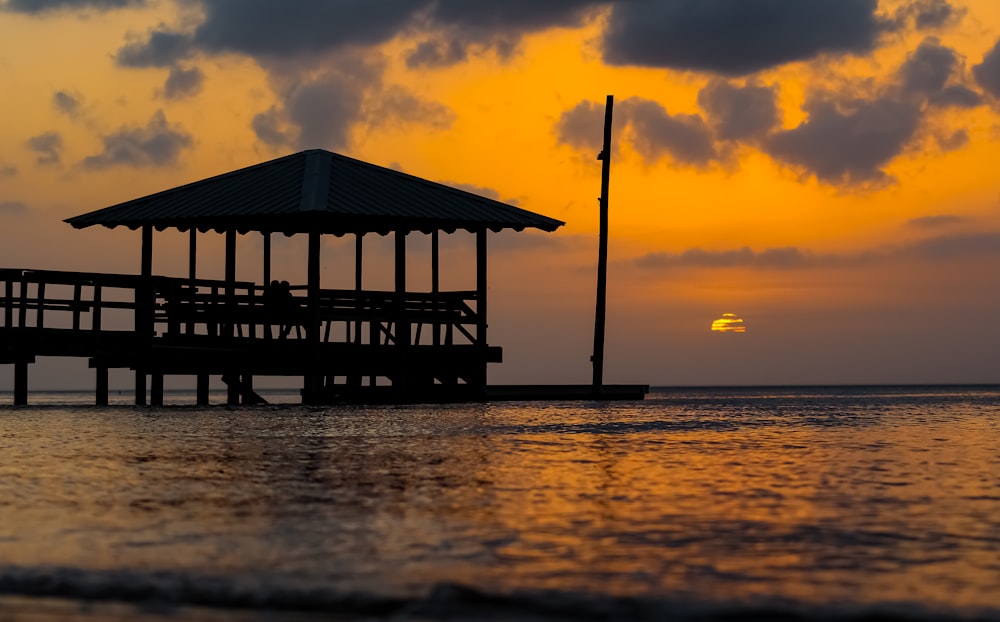 brown gazebo near body of water