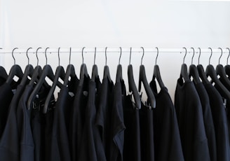 black clothes hanged in rack