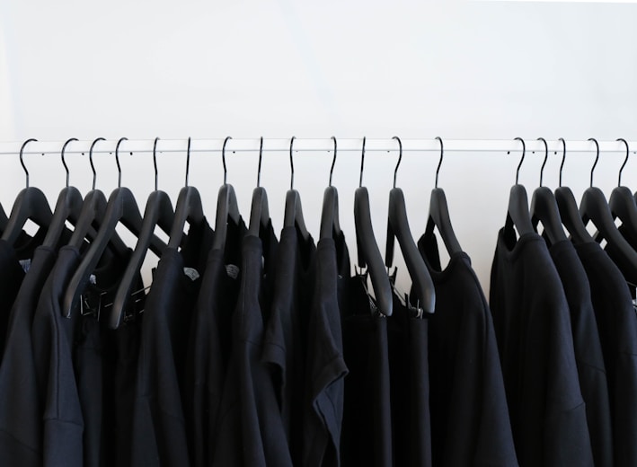 black clothes hanged in rack