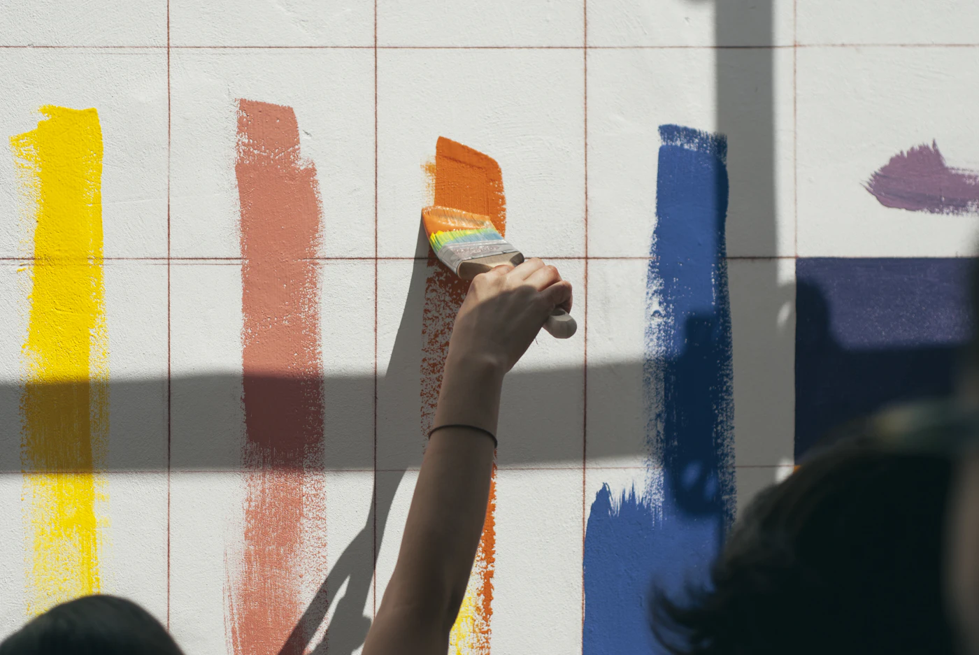 A wall being rolled with a fresh coat of paint