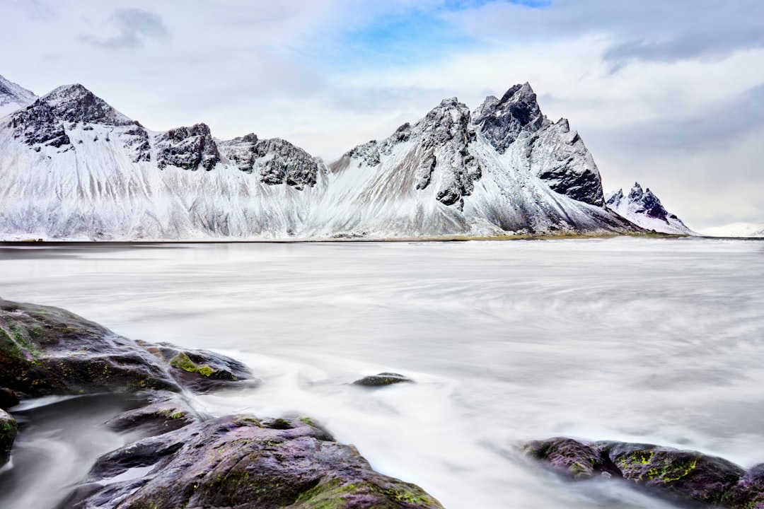 snow covered mountain under cloudy sky during daytime