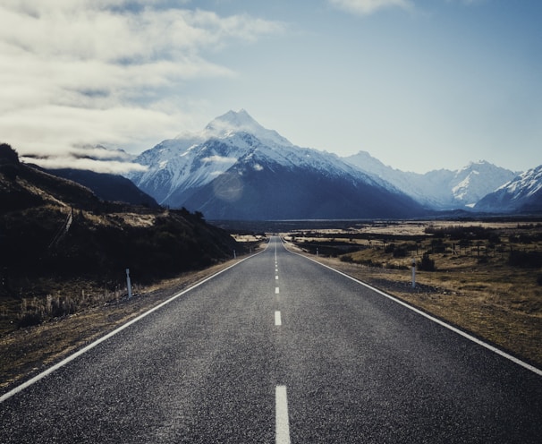 road near mountain during daytime