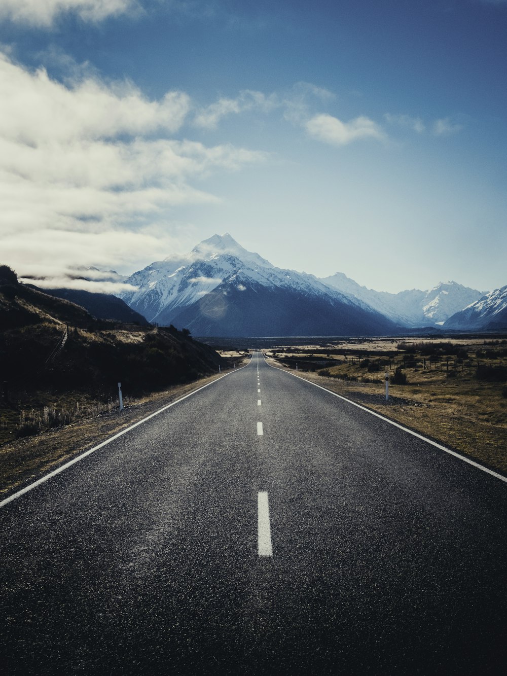 road near mountain during daytime