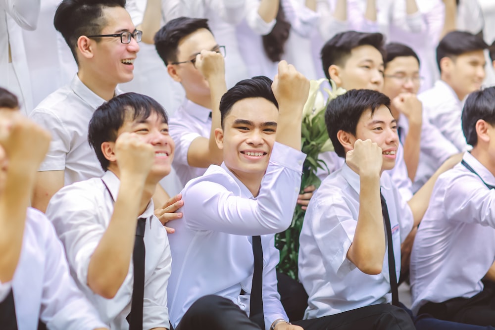 a group of young men sitting next to each other