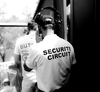 security personnel with headphones grayscale photo