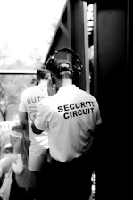 A security team coordinating via radio during an outdoor event, ensuring smooth operations.