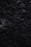 a black and white photo of rocks and water