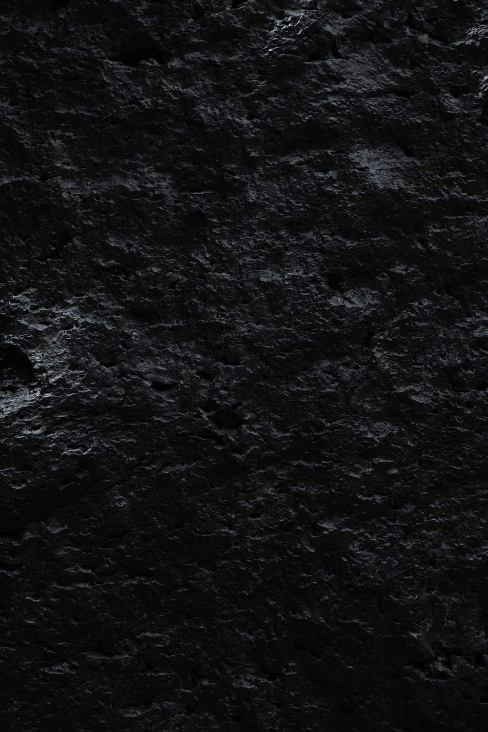 a black and white photo of rocks and water