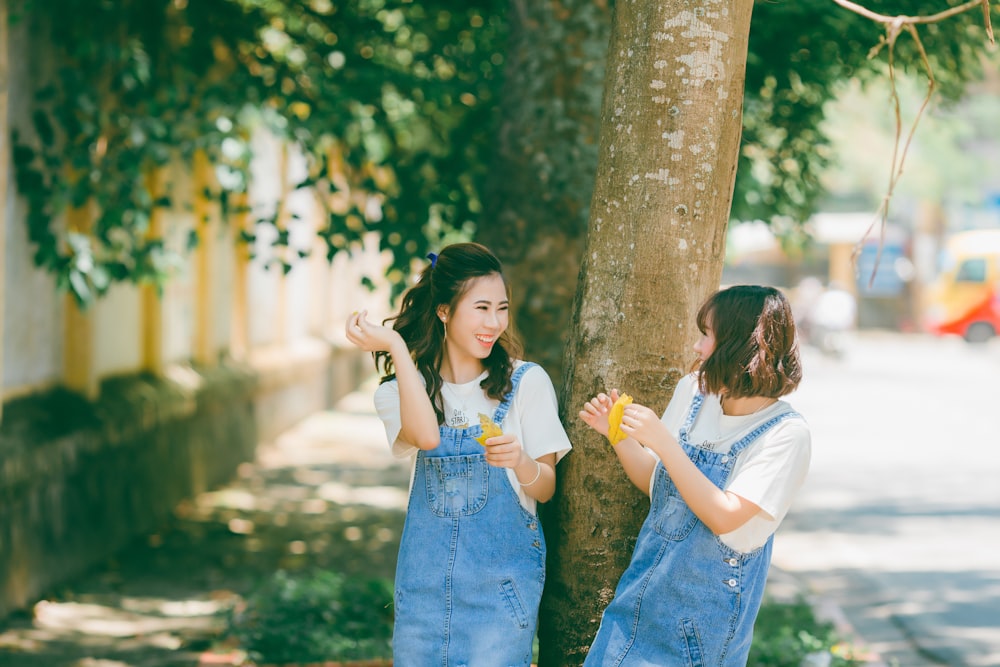 two women wearing blue denim tops