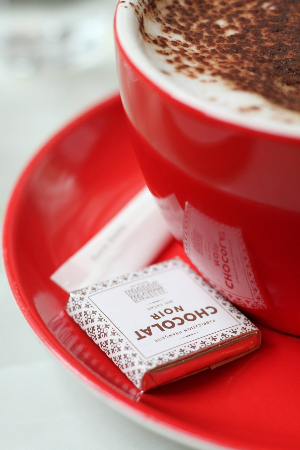 red ceramic mug with suacer