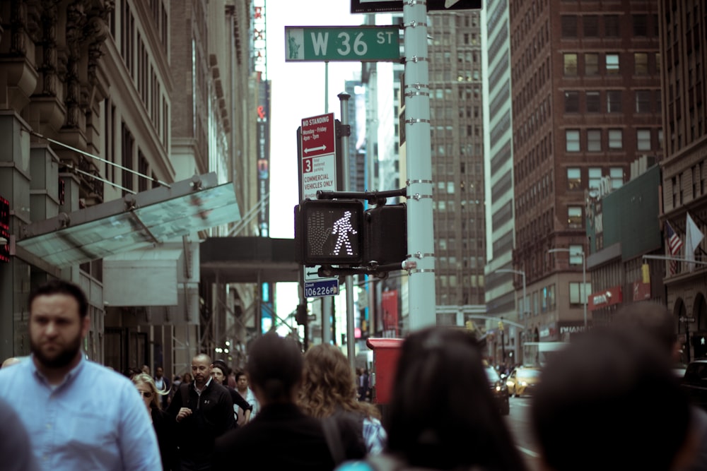 people at W36 street near brown buildings during daytime