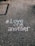 love one another chalk written on concrete floor
