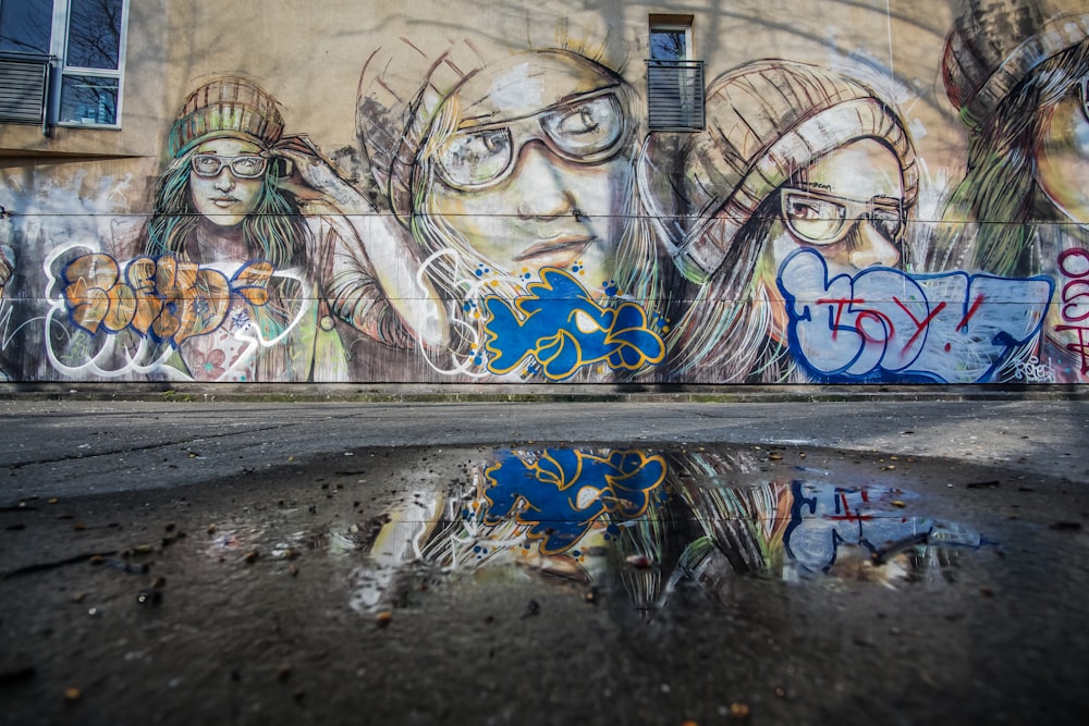 graffiti of person wearing hat and eyeglasses