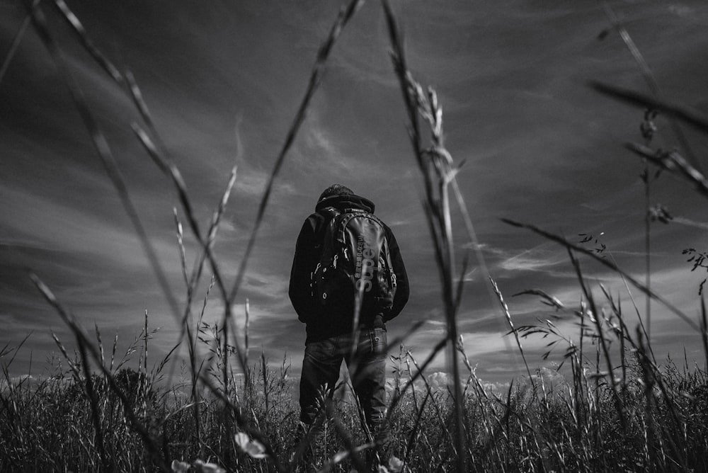 grayscale photo of man in fields