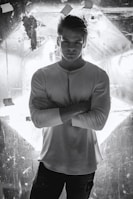 A confident man dressed in Lumina Apparel’s masculine collection, standing against a minimalist backdrop.