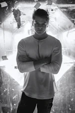 A close-up shot of a man wearing a sleek black shirt from eled trade, standing confidently in soft natural light.