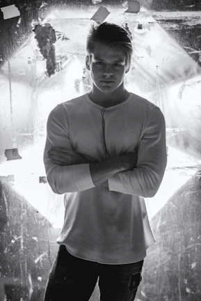 Close-up of a confident man in security uniform standing with crossed arms.