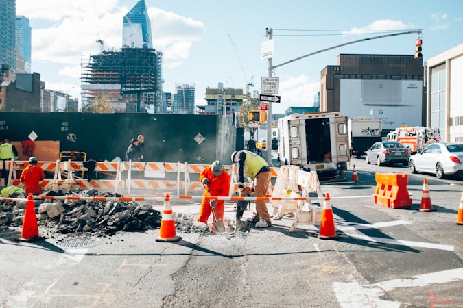 A worker on a city street during roadwork, similar to crews rebuilding Boulder Highway in Henderson