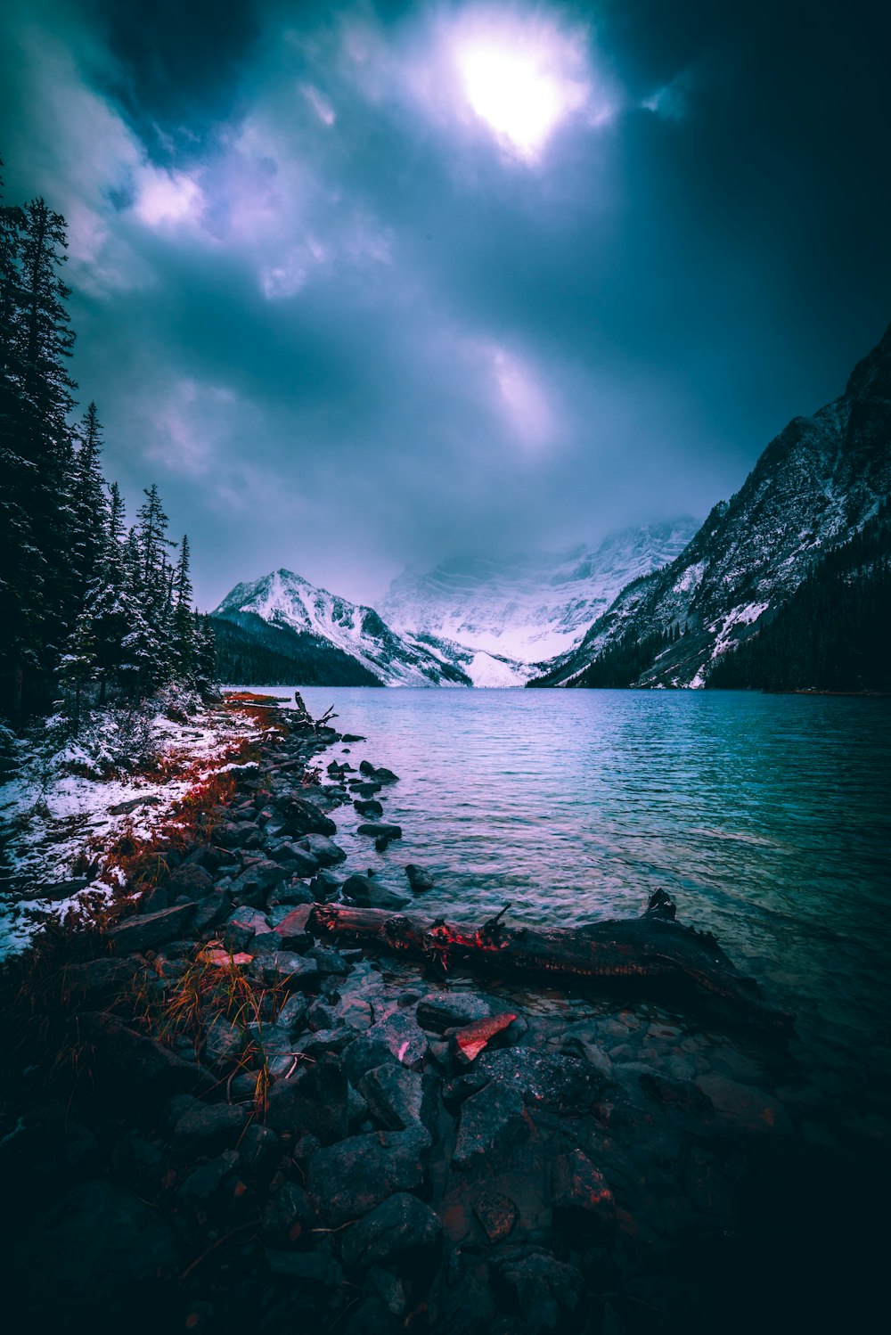 gray mountain beside body of water