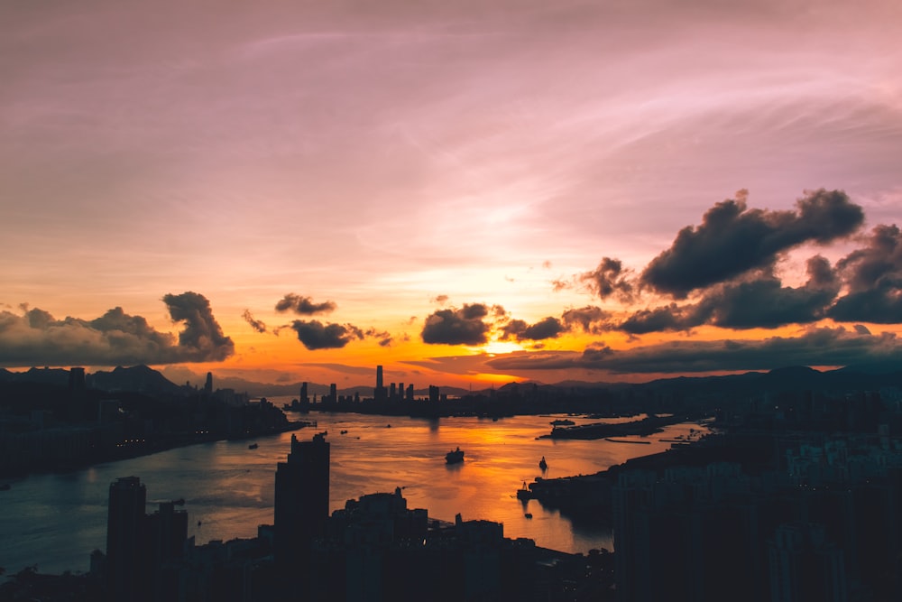 silhouette of buildings near body of water