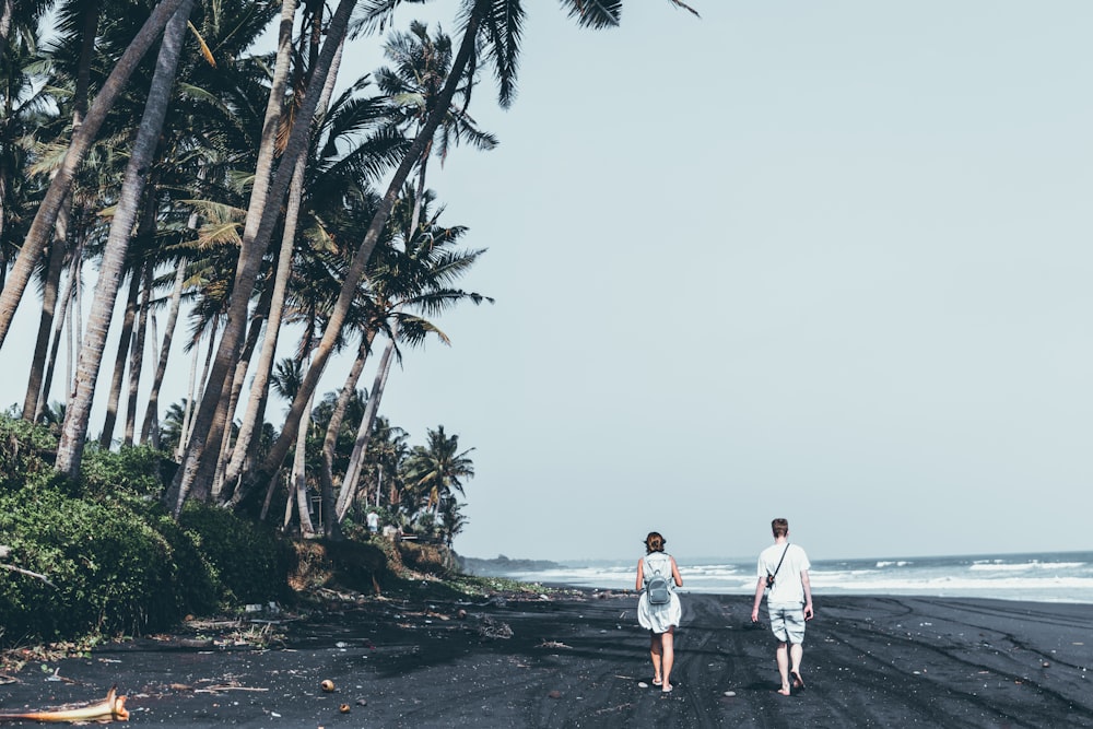 man and woman standing on the seashore