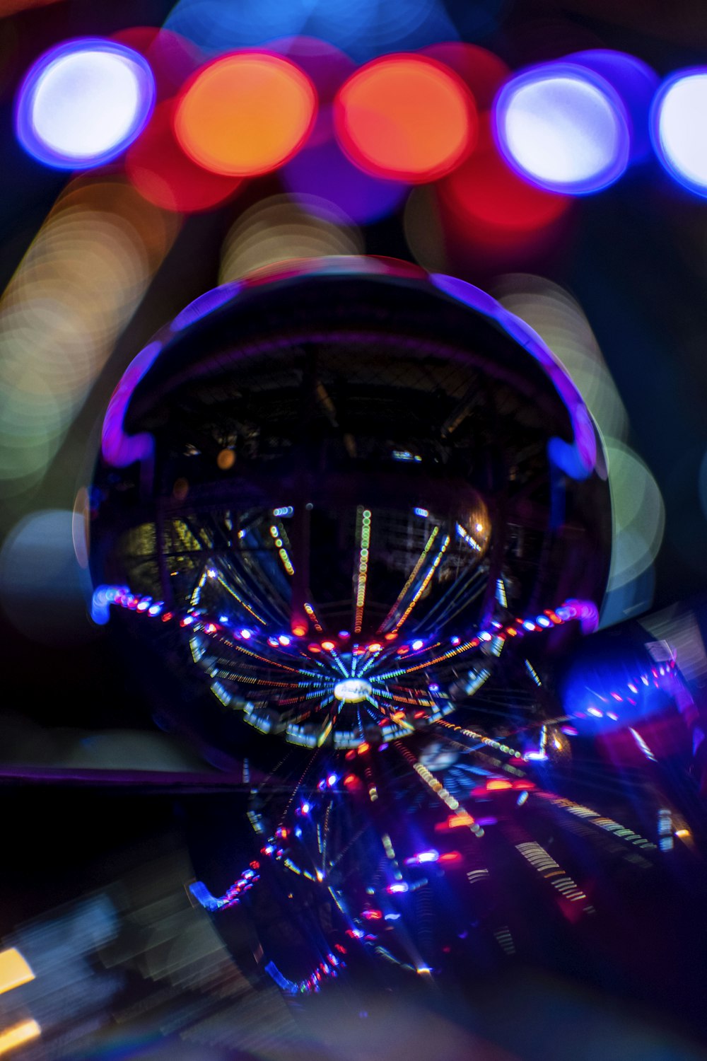 a blurry photo of a ferris wheel at night