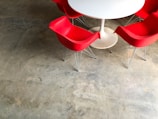 red plastic chairs near white pedestal table