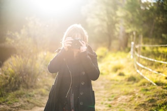 A photographer capturing a vibrant outdoor scene with natural light.