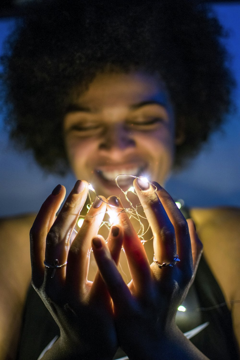 woman holding white string lights