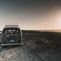 gray van parked near grass field