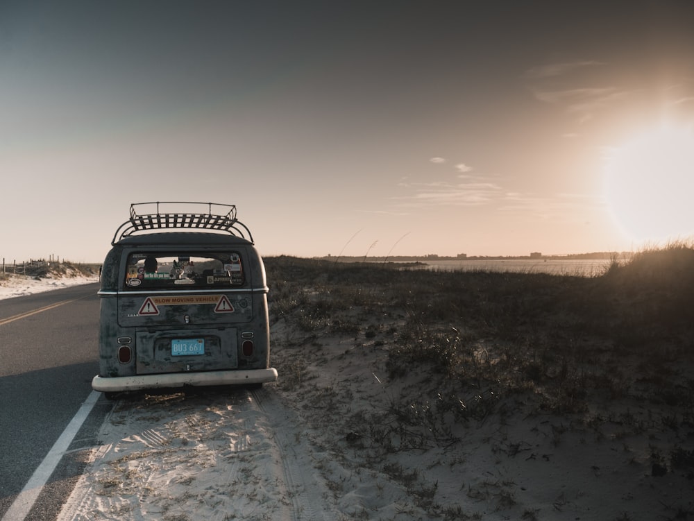 gray van parked near grass field