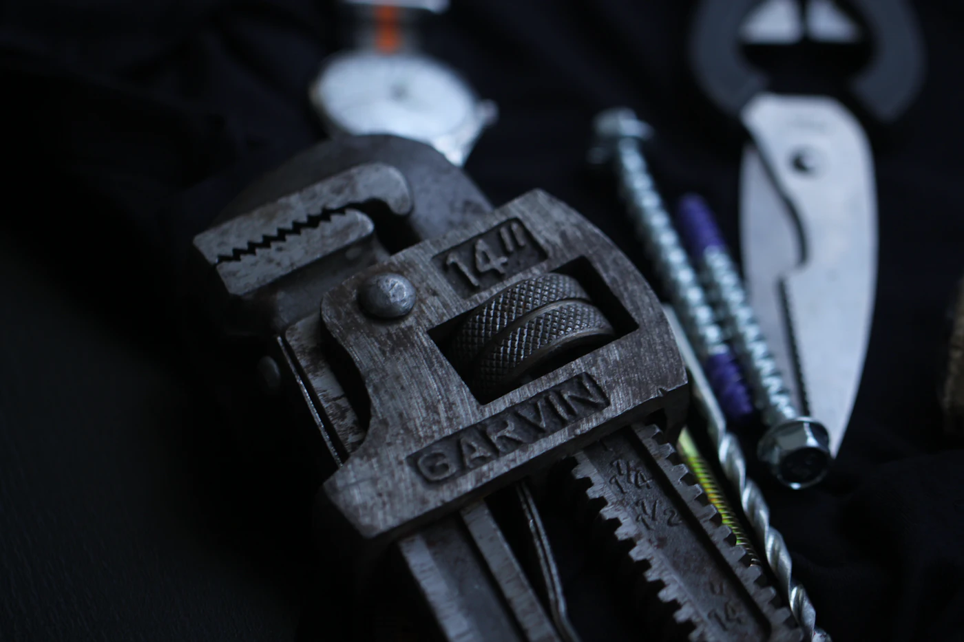 Pipe wrench and plumbing tools used for secure gas-line fitting