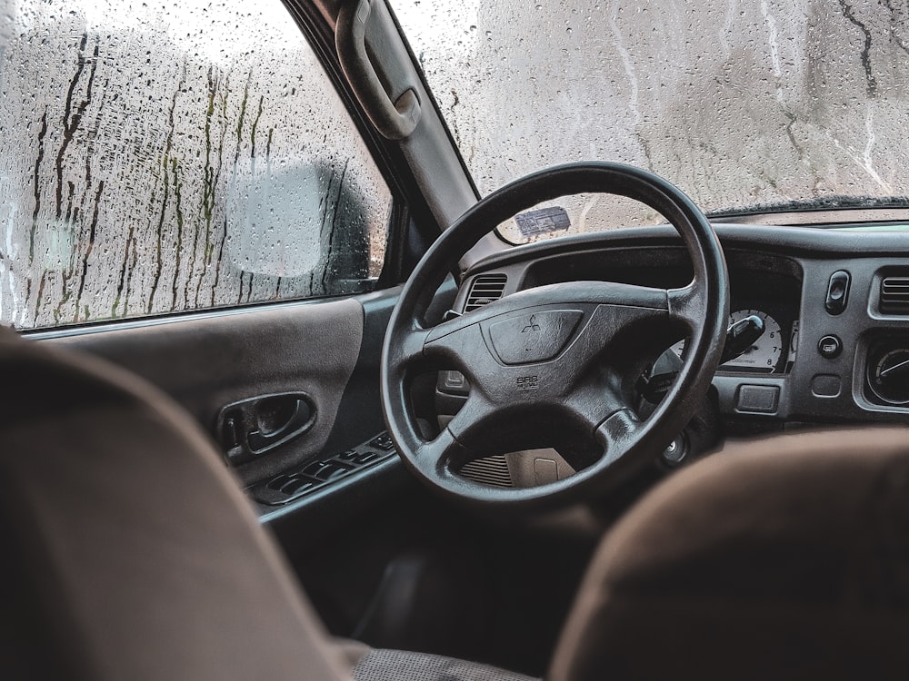 black Mitsubishi vehicle steering wheel