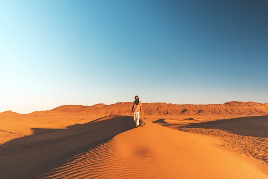 man walking on desert in Merzouga Morocco