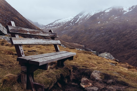 brown wooden bench on mountainside at daytime in Ben Nevis United Kingdom