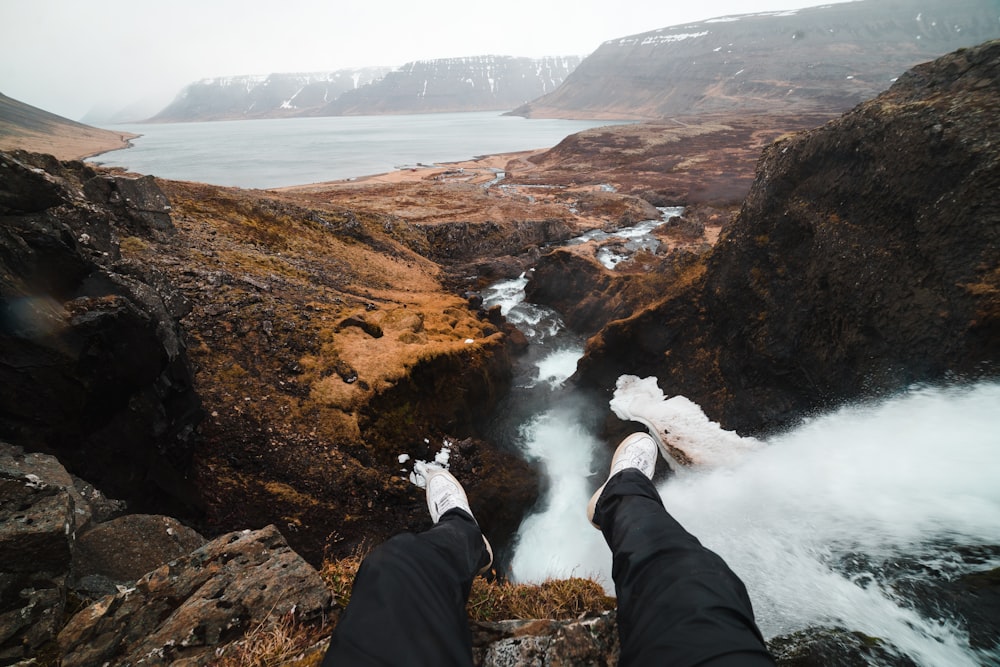 person sitting on the cliff