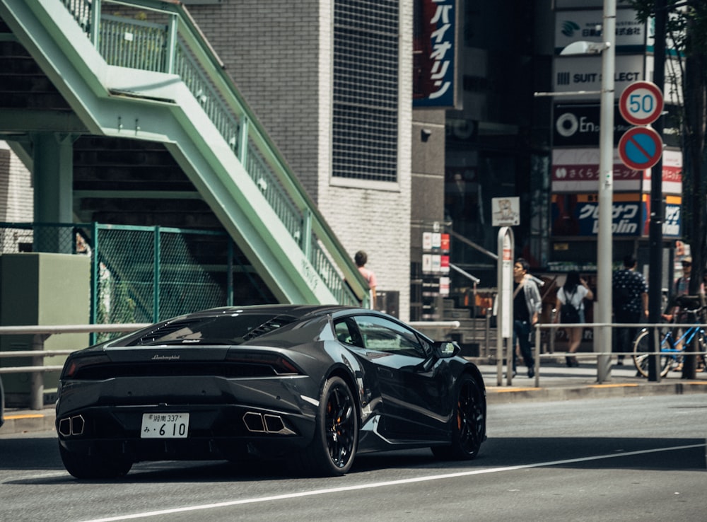black sports coupe near staircase